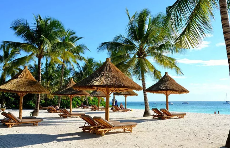 Fly to the white sands of the island of Zanzibar.